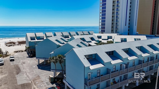 birds eye view of property featuring a water view and a view of the beach