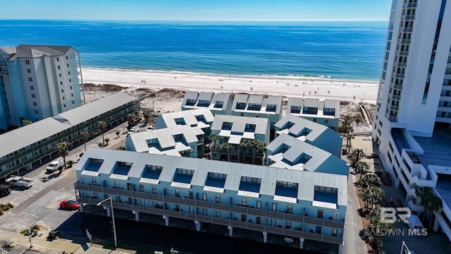 drone / aerial view featuring a water view and a view of the beach