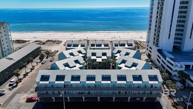 bird's eye view featuring a water view and a beach view