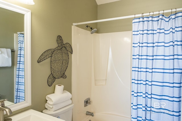 bathroom with a sink, toilet, and shower / tub combo with curtain