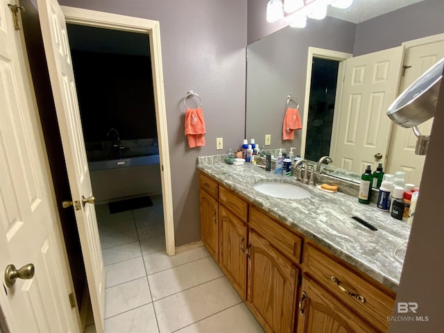 bathroom featuring tile patterned flooring and vanity