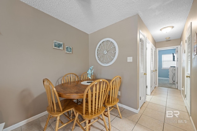 tiled dining room with a textured ceiling