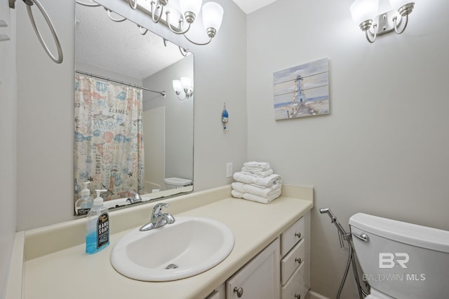 bathroom featuring curtained shower, a textured ceiling, vanity, and toilet