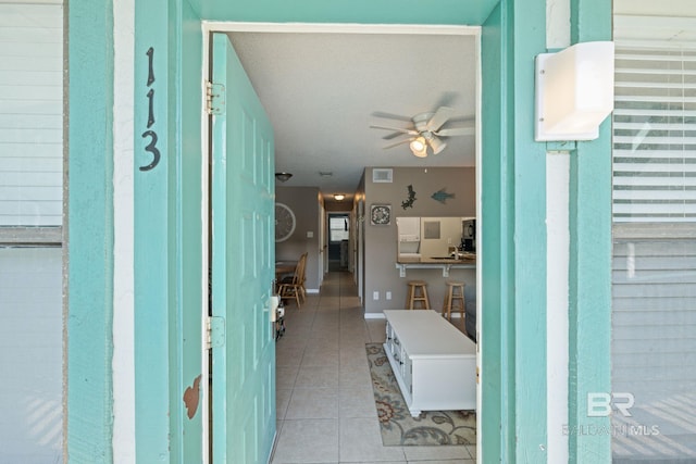 interior space with ceiling fan and light tile patterned floors