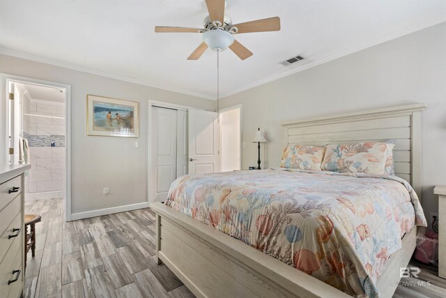 bedroom featuring ceiling fan, crown molding, a closet, light wood-type flooring, and connected bathroom