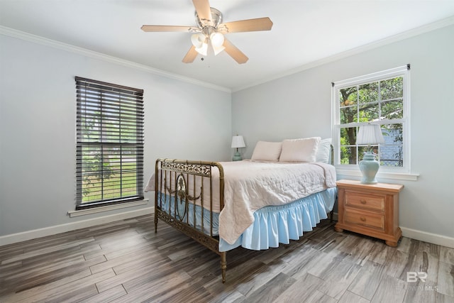 bedroom with crown molding, ceiling fan, and multiple windows