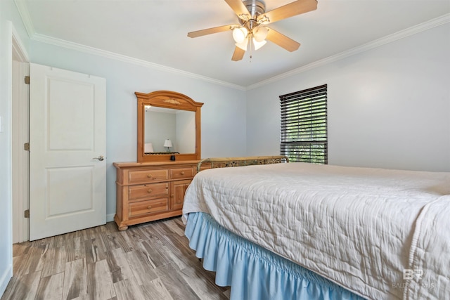 bedroom with ceiling fan, light hardwood / wood-style floors, and crown molding