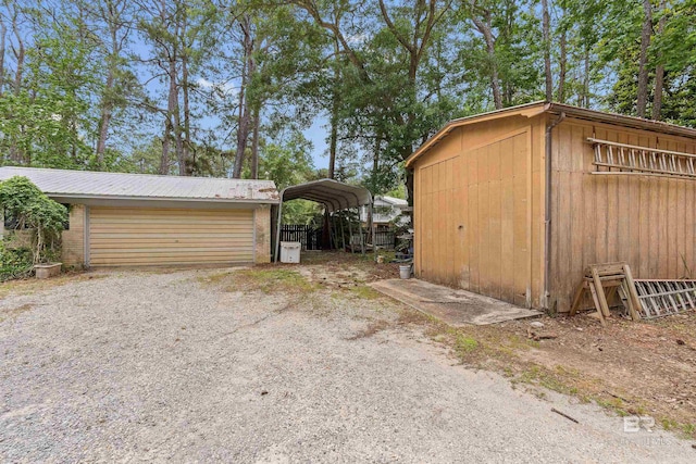 view of outdoor structure with a carport and a garage