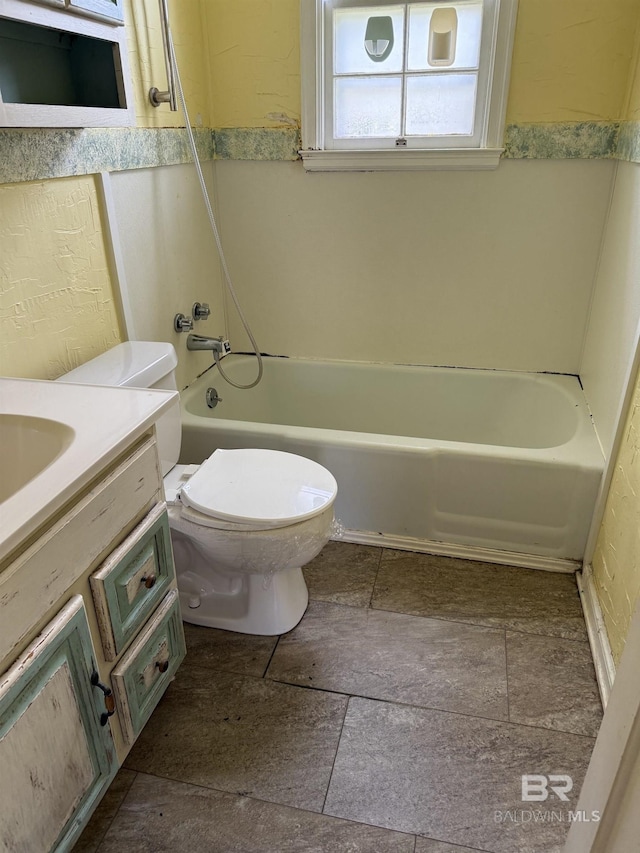 502 E Myrtle Ave, Foley, AL 36535 - full bathroom with vanity, washtub / shower combination, and stone finish floors