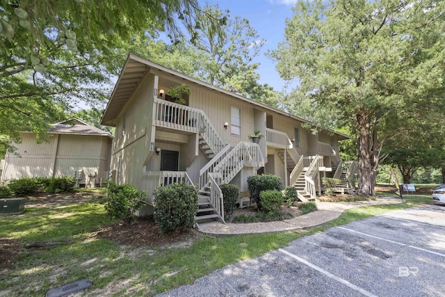 2086 N Seacliff Dr Unit 2086, Daphne, AL 36526 - view of building exterior featuring stairway and uncovered parking