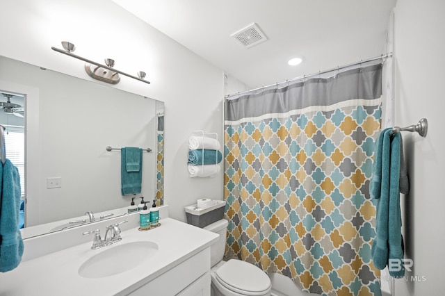 full bathroom with a shower with curtain, visible vents, vanity, and toilet