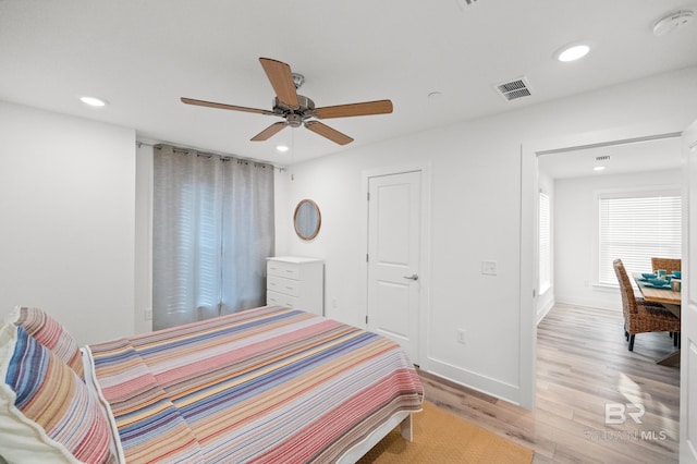 bedroom featuring recessed lighting, a ceiling fan, baseboards, visible vents, and light wood-type flooring