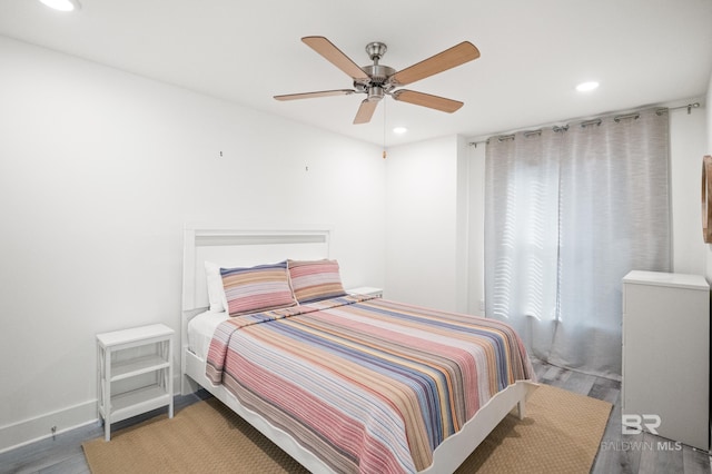 bedroom featuring baseboards, ceiling fan, wood finished floors, and recessed lighting