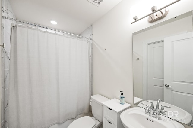 bathroom with visible vents, a sink, and toilet