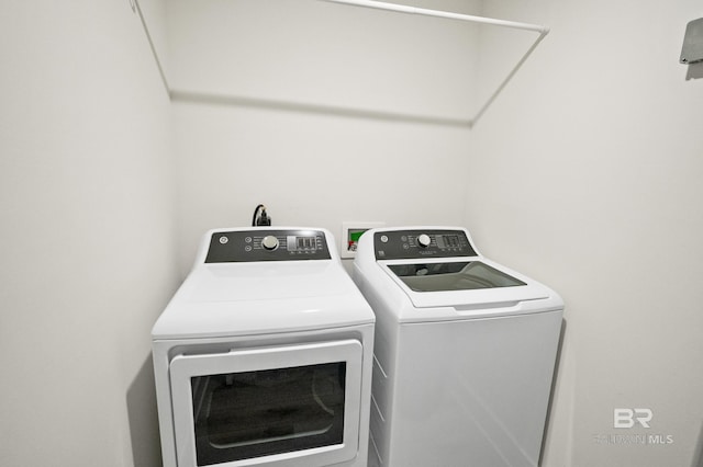 washroom featuring laundry area and separate washer and dryer