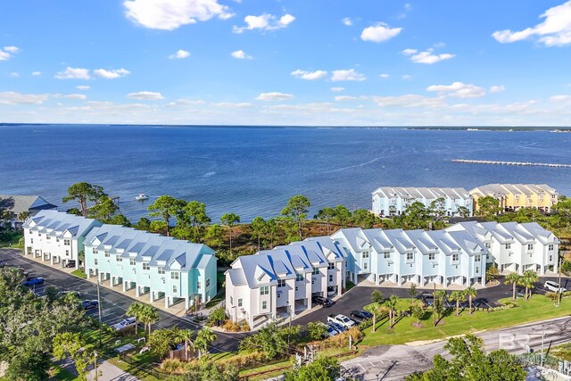 drone / aerial view with a water view and a residential view