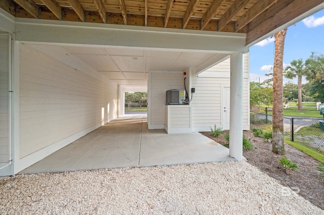 view of patio / terrace with gravel driveway and fence