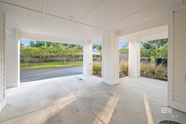 garage with driveway and fence