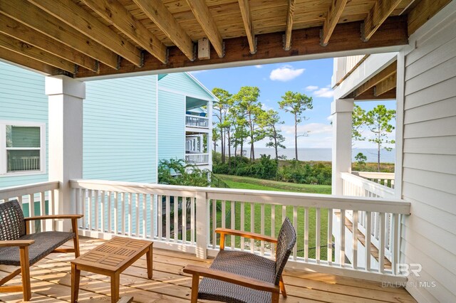 balcony featuring a deck with water view