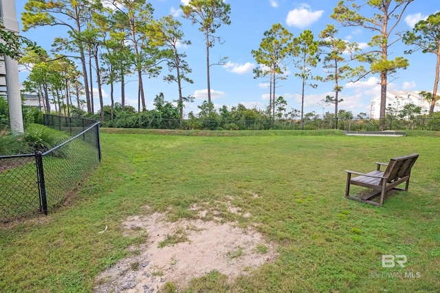 view of home's community featuring a lawn and fence