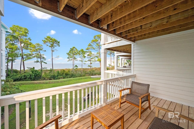 wooden terrace featuring a lawn