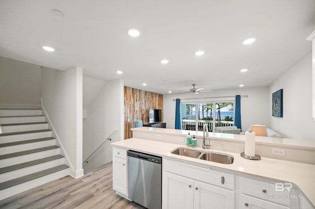 kitchen with recessed lighting, a sink, white cabinets, light countertops, and dishwasher