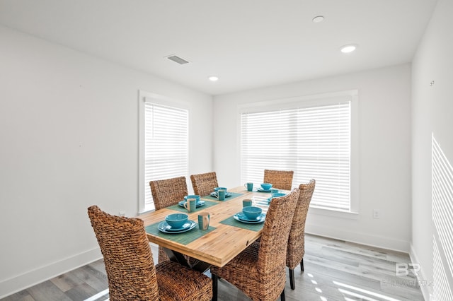 dining room featuring light wood finished floors, baseboards, visible vents, and recessed lighting