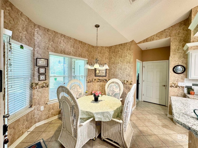 tiled dining room with a textured ceiling and vaulted ceiling