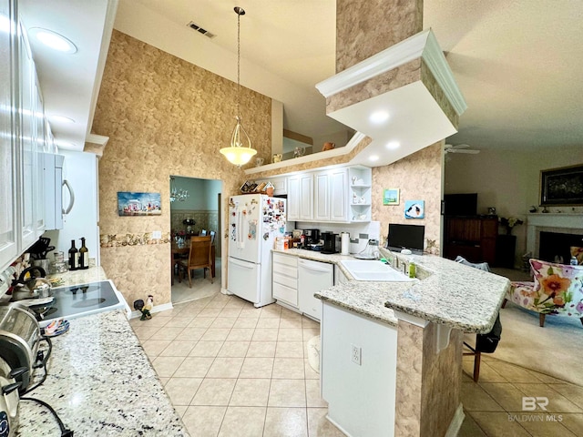 kitchen featuring white cabinets, kitchen peninsula, white appliances, decorative light fixtures, and a kitchen breakfast bar