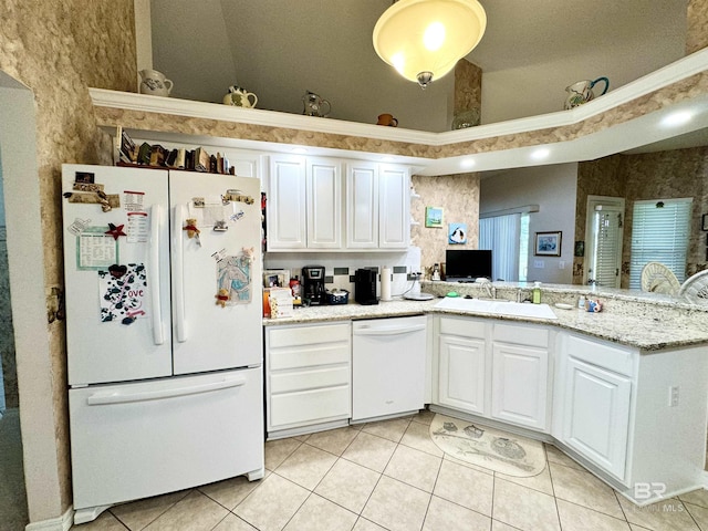 22835 County Road 12, Foley, AL 36535 - kitchen with white appliances, a sink, light tile patterned floors, white cabinetry, and vaulted ceiling