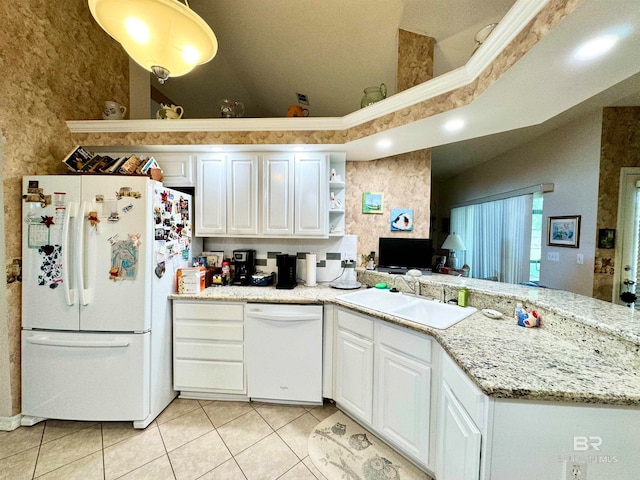 kitchen with white appliances, white cabinetry, sink, and light tile patterned floors