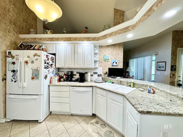 22835 County Road 12, Foley, AL 36535 - kitchen featuring white appliances, a sink, light tile patterned floors, white cabinetry, and a peninsula