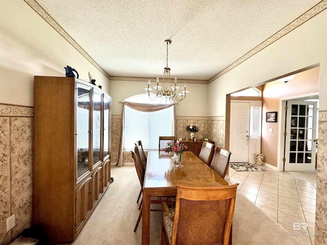 22835 County Road 12, Foley, AL 36535 - dining room featuring a chandelier, a textured ceiling, a wainscoted wall, and crown molding