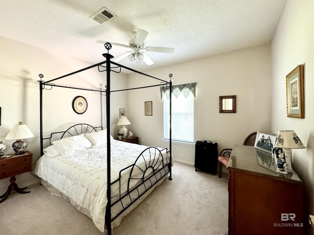 22835 County Road 12, Foley, AL 36535 - bedroom featuring light carpet, a textured ceiling, baseboards, and a ceiling fan