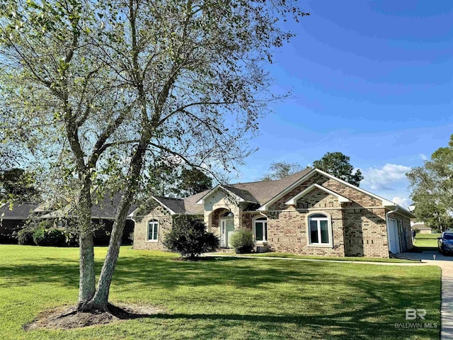 22835 County Road 12, Foley, AL 36535 - view of front facade with an attached garage, a front lawn, brick siding, and driveway