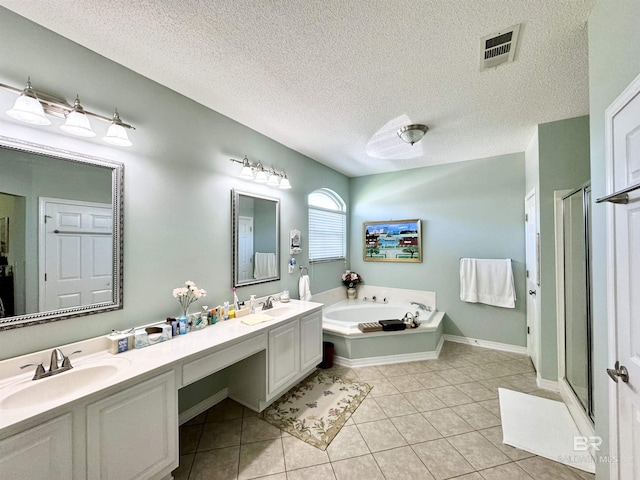 22835 County Road 12, Foley, AL 36535 - full bathroom featuring a garden tub, a shower stall, double vanity, tile patterned flooring, and a textured ceiling