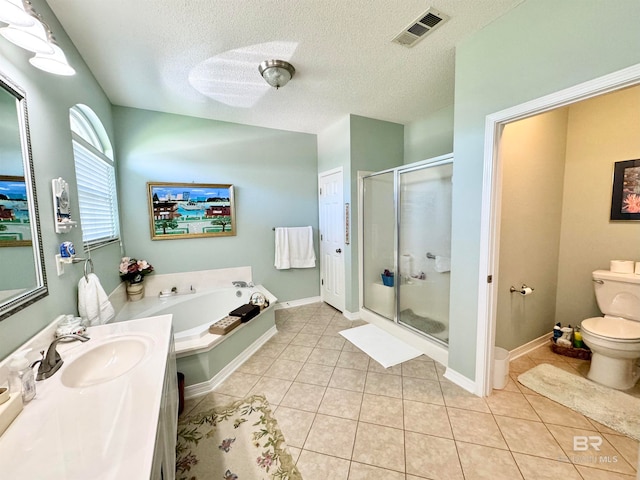 full bathroom with independent shower and bath, a textured ceiling, tile patterned flooring, and toilet