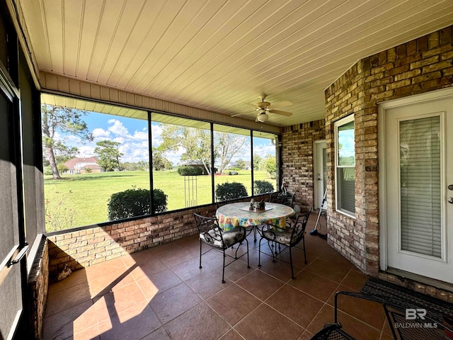 sunroom with ceiling fan and wood ceiling