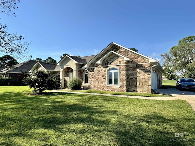 22835 County Road 12, Foley, AL 36535 - view of front facade featuring a garage, brick siding, a front lawn, and concrete driveway