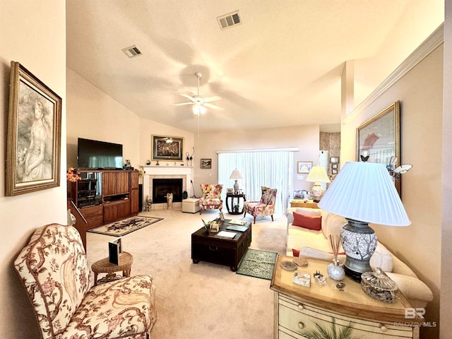 living room with a textured ceiling, lofted ceiling, light carpet, and ceiling fan