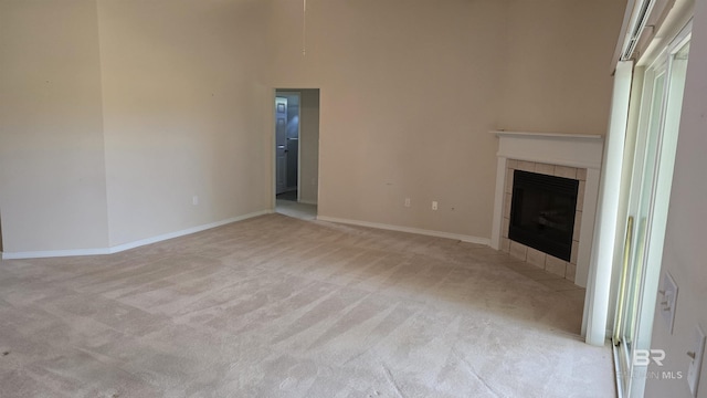 22835 County Road 12, Foley, AL 36535 - unfurnished living room featuring light carpet, a tile fireplace, and baseboards