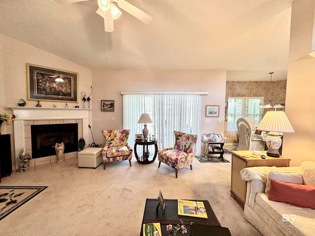 carpeted living room with a textured ceiling, a fireplace, ceiling fan, and a wealth of natural light