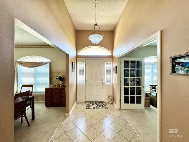 22835 County Road 12, Foley, AL 36535 - foyer with light tile patterned floors, healthy amount of natural light, light carpet, baseboards, and a towering ceiling