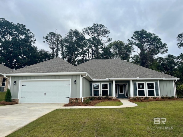 view of front of home with a front lawn and a garage