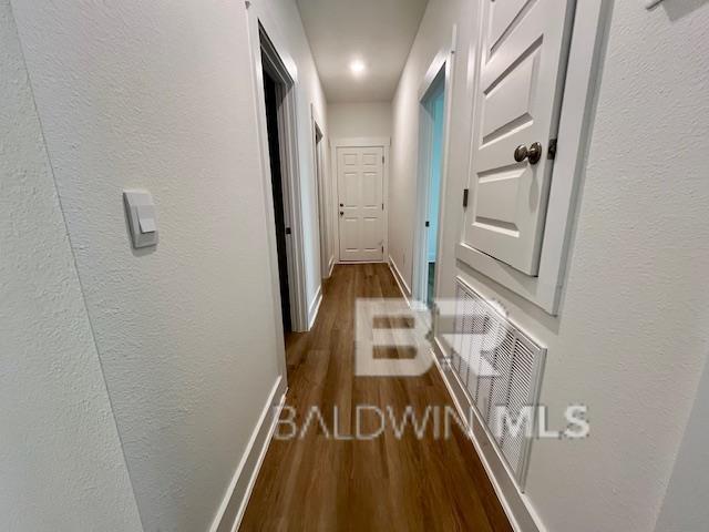 hallway featuring dark hardwood / wood-style floors