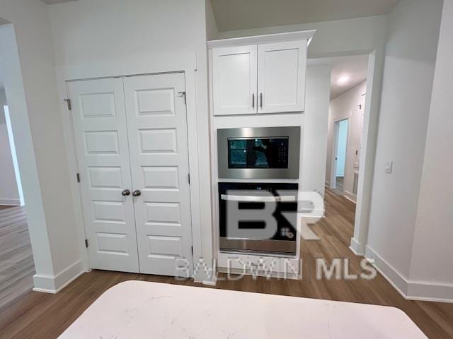 kitchen featuring stainless steel appliances, white cabinets, and dark hardwood / wood-style floors