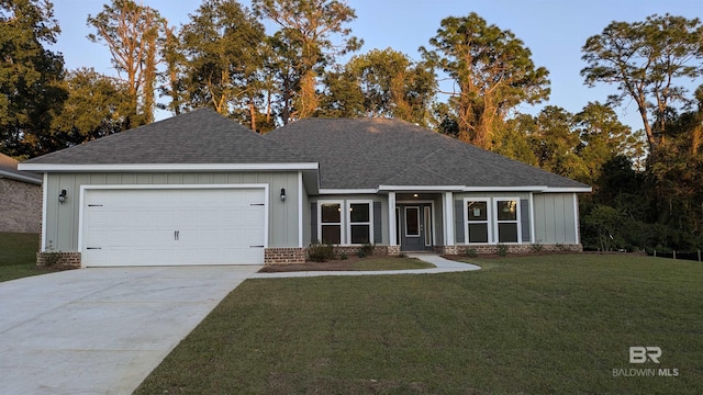 view of front facade with a front yard and a garage