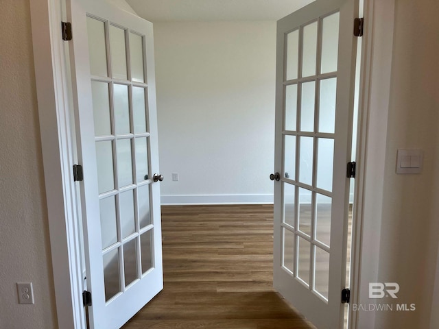 corridor featuring dark wood-type flooring and french doors