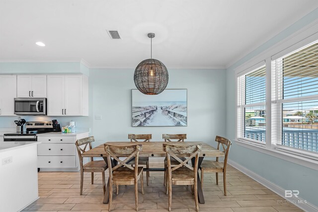 1337 W Lagoon Ave, Gulf Shores, AL 36542 - dining area featuring a notable chandelier, baseboards, wood tiled floor, visible vents, and ornamental molding