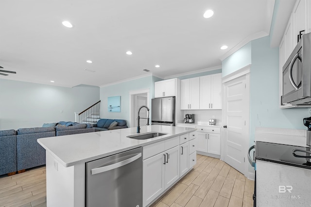 1337 W Lagoon Ave, Gulf Shores, AL 36542 - kitchen featuring wood tiled floor, a sink, open floor plan, and appliances with stainless steel finishes